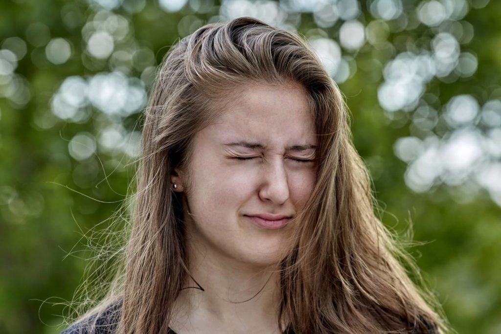 Young woman squinting